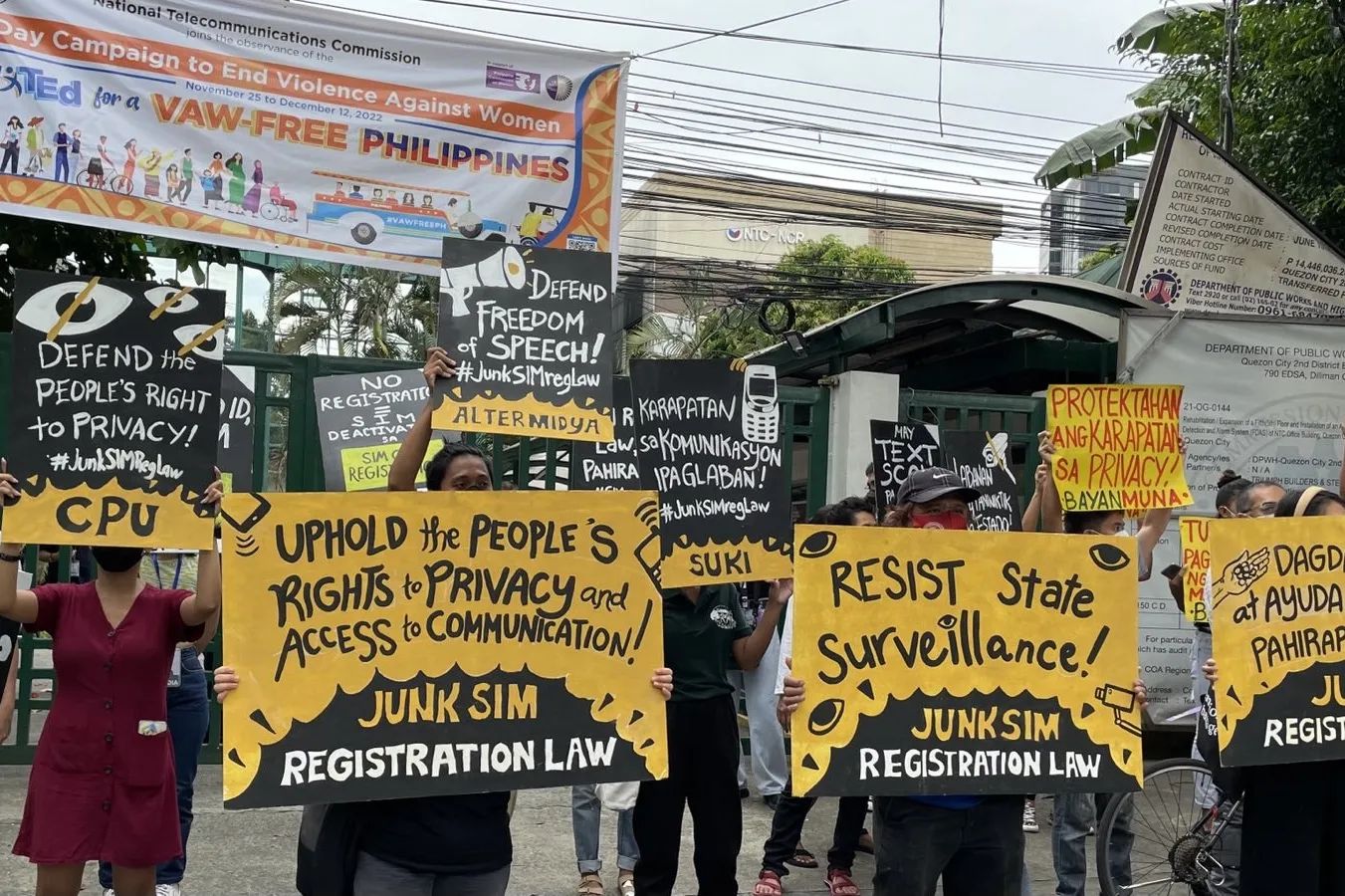 Photo is of protestors against the SIM registration law. Protestors' signs say in English: 
